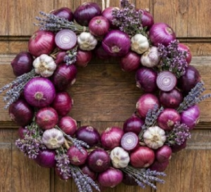 purple and white wreath made of purple onions and garlic to ward off sickness because they inhibit microbial